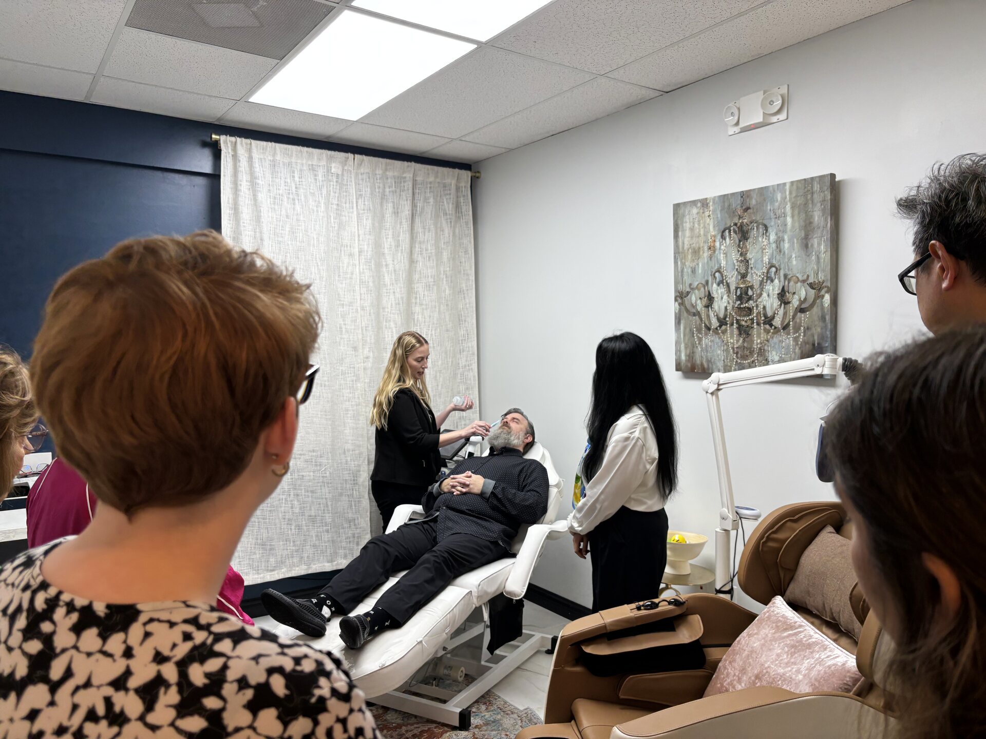 Workshop attendees watching a live dry eye treatment demo